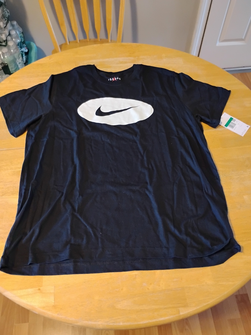 Nike Black Short-Sleeve Tee with White Oval Swoosh